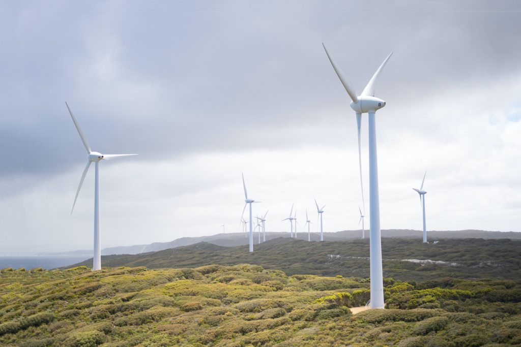 Photo Of Wind Turbines Under Cloudy Sky. Source: Harry Cunningham