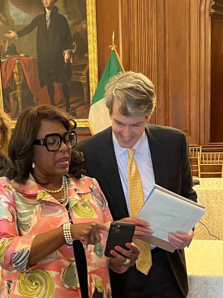 Representative Terri Sewell (D-AL) shows NABL 2023 President her phone in the U.S. Capitol Building.