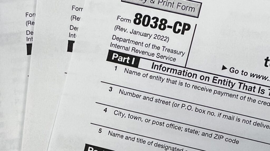 Stack of printed IRS Forms 8038-CP