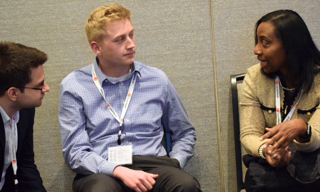 Mentor and mentees having an aside conversation during a NABL conference.