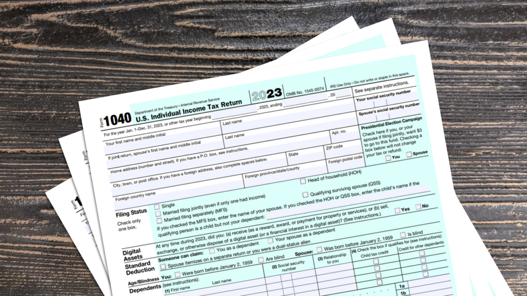 IRS Form 1040 documents on a wooden table.