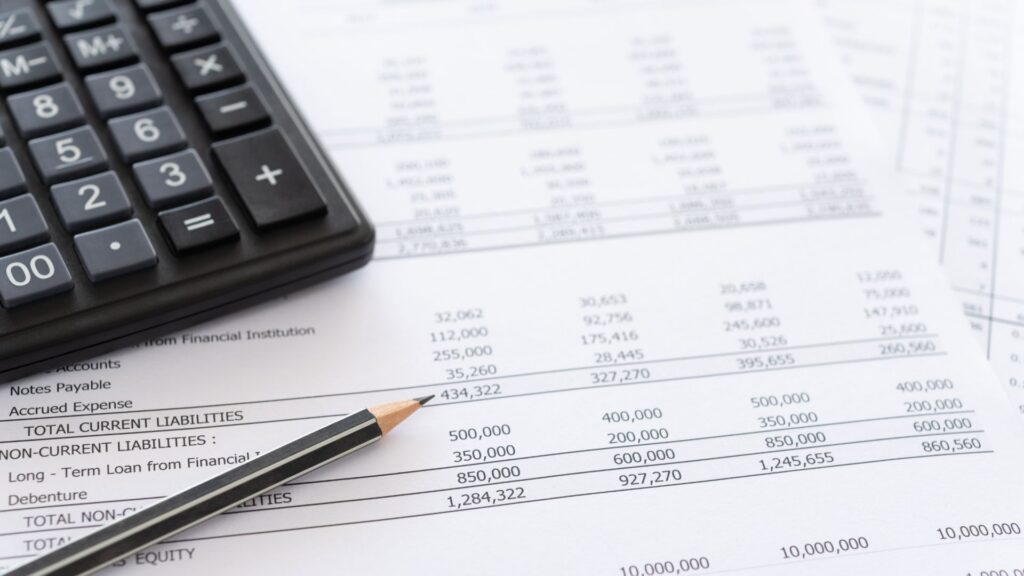 Image of a balance sheet with a calculator and pencil.